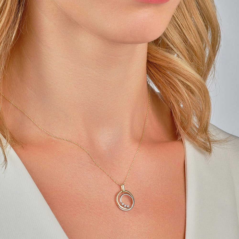 9ct yellow gold and white gold diamond swirl necklace on model