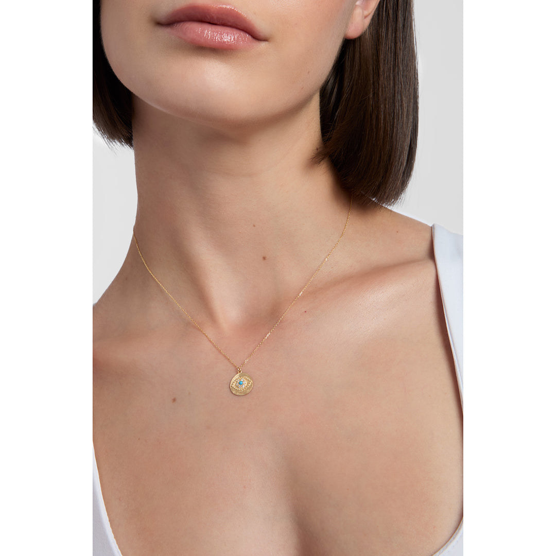 model wearing 9ct gold cubic zirconia evil eye pendant necklace