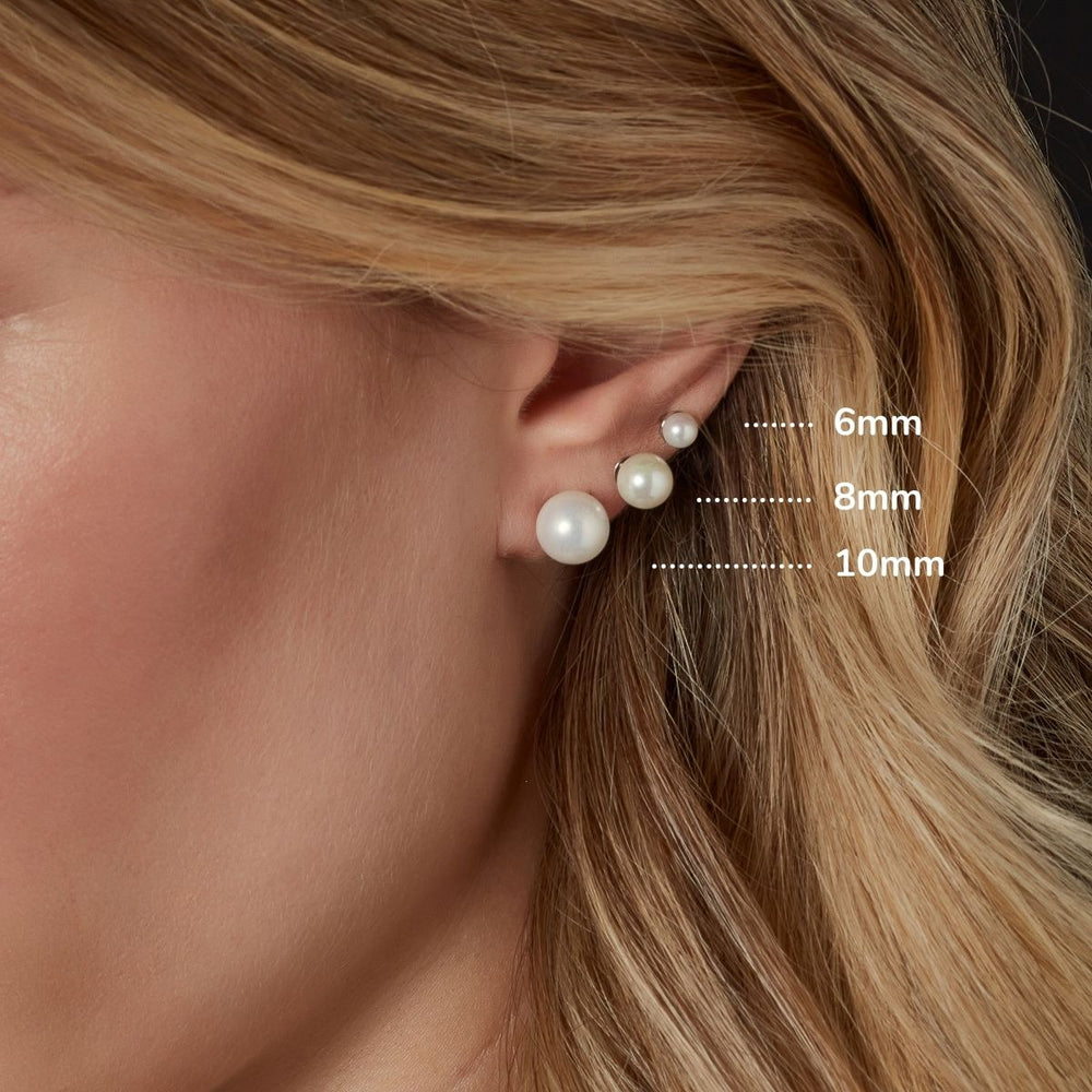 Model wearing pearl stud earrings