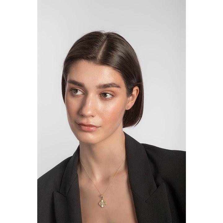Model wearing 9ct gold flower stud earrings and necklace set