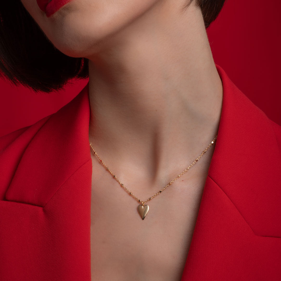 model wearing heart drop necklace in gold