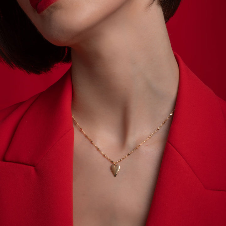 model wearing heart drop necklace in gold