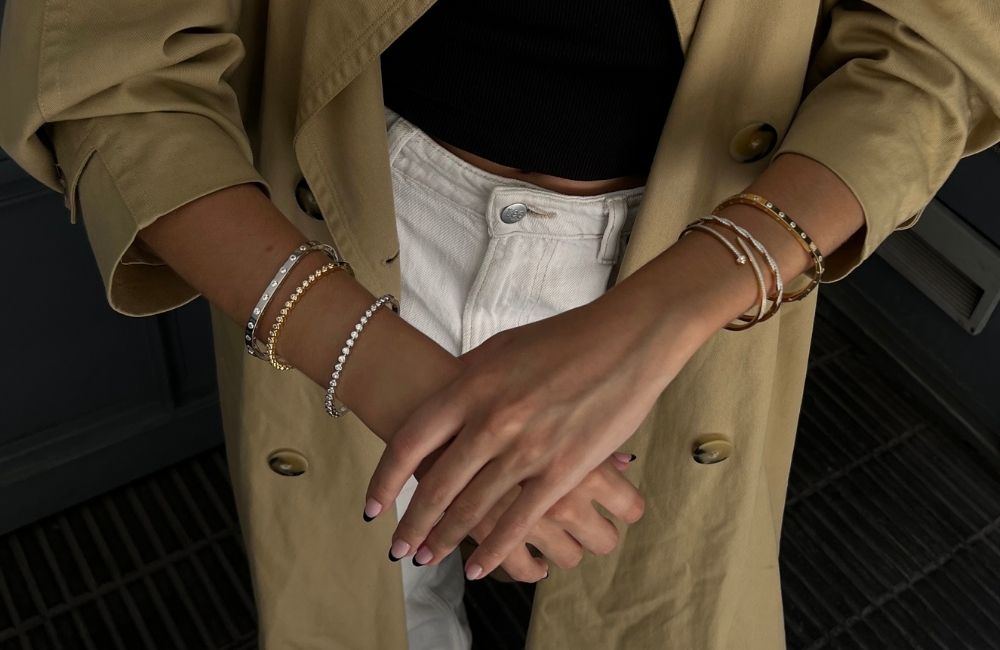 model wearing gold plated and sterling silver bangle stack