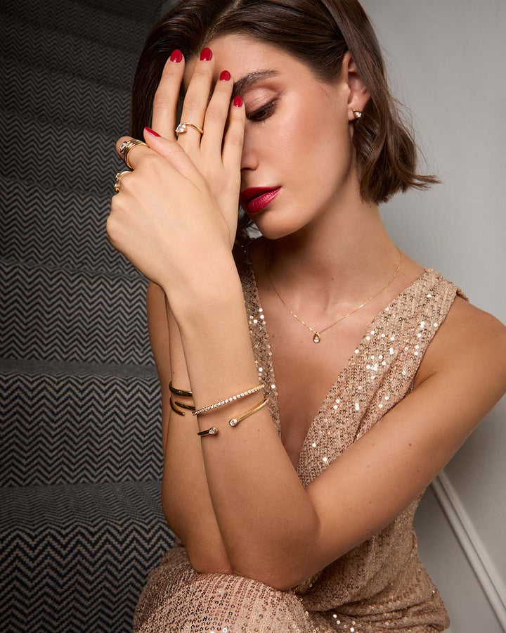 model wearing gold plated bracelet stack