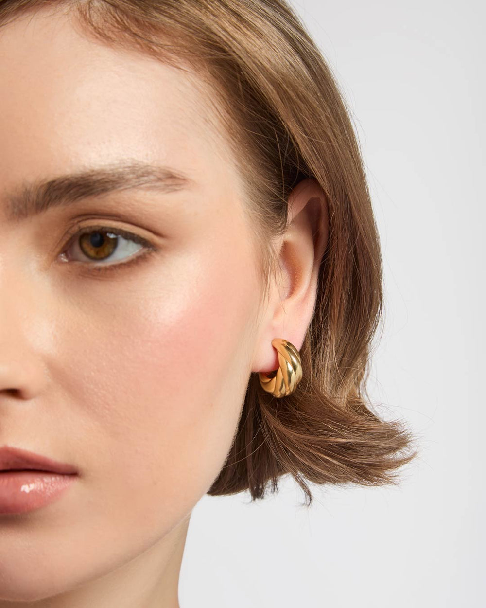 gold plated croissant hoop earrings on model
