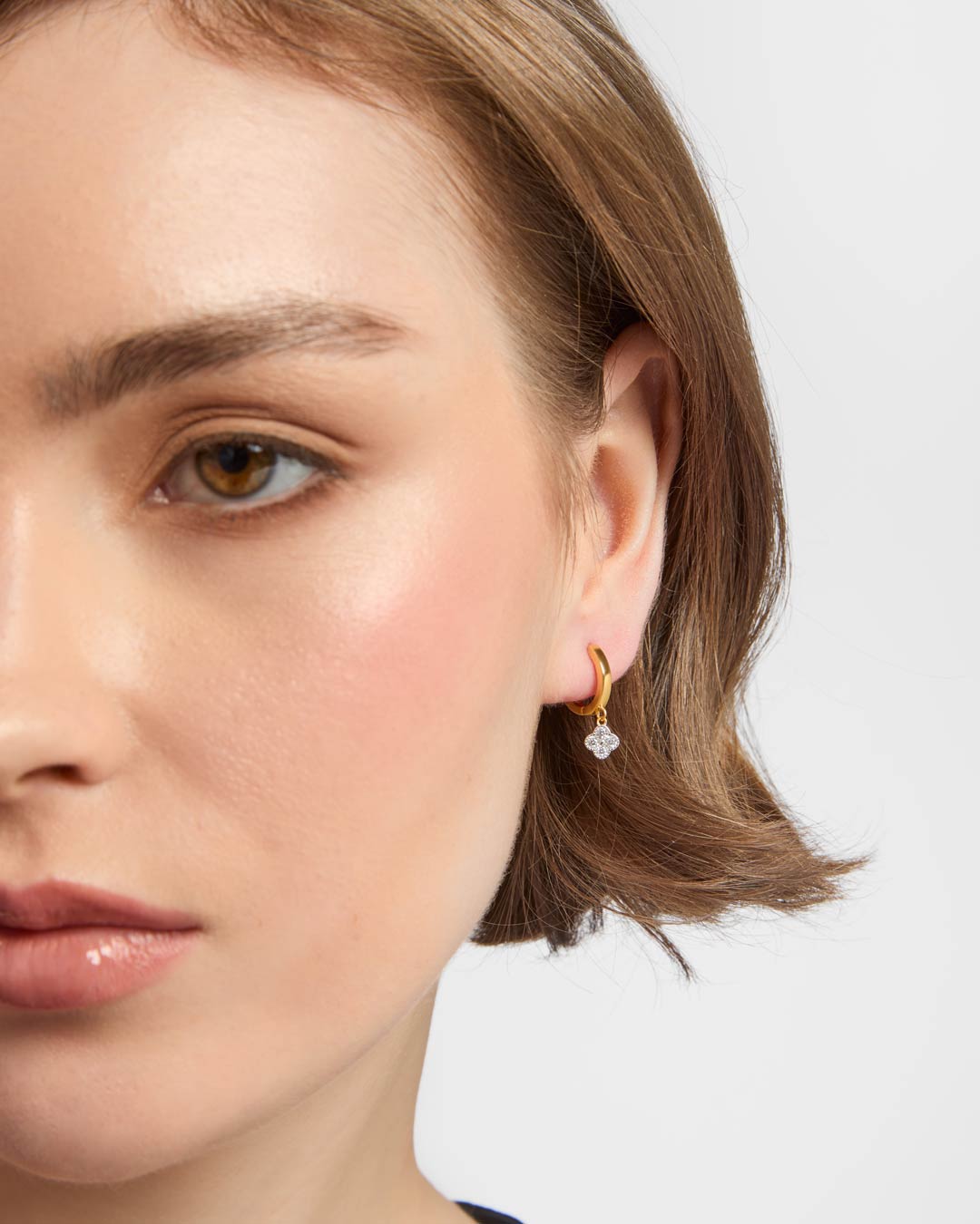 gold plated huggie earrings on model