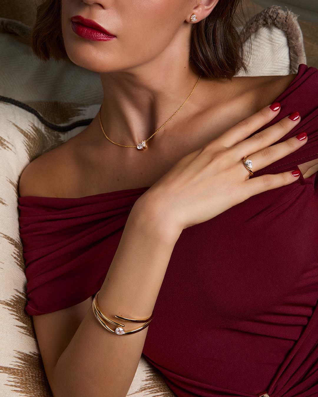 model wearing gold plated bracelet stack with necklace and earrings