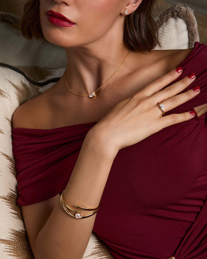 model wearing gold plated bracelet stack with necklace and earrings