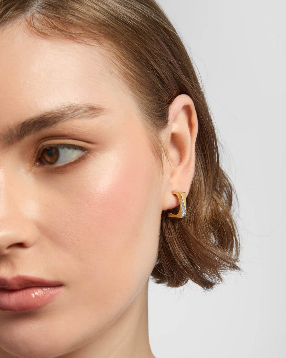 model wearing gold plated square hoop earrings