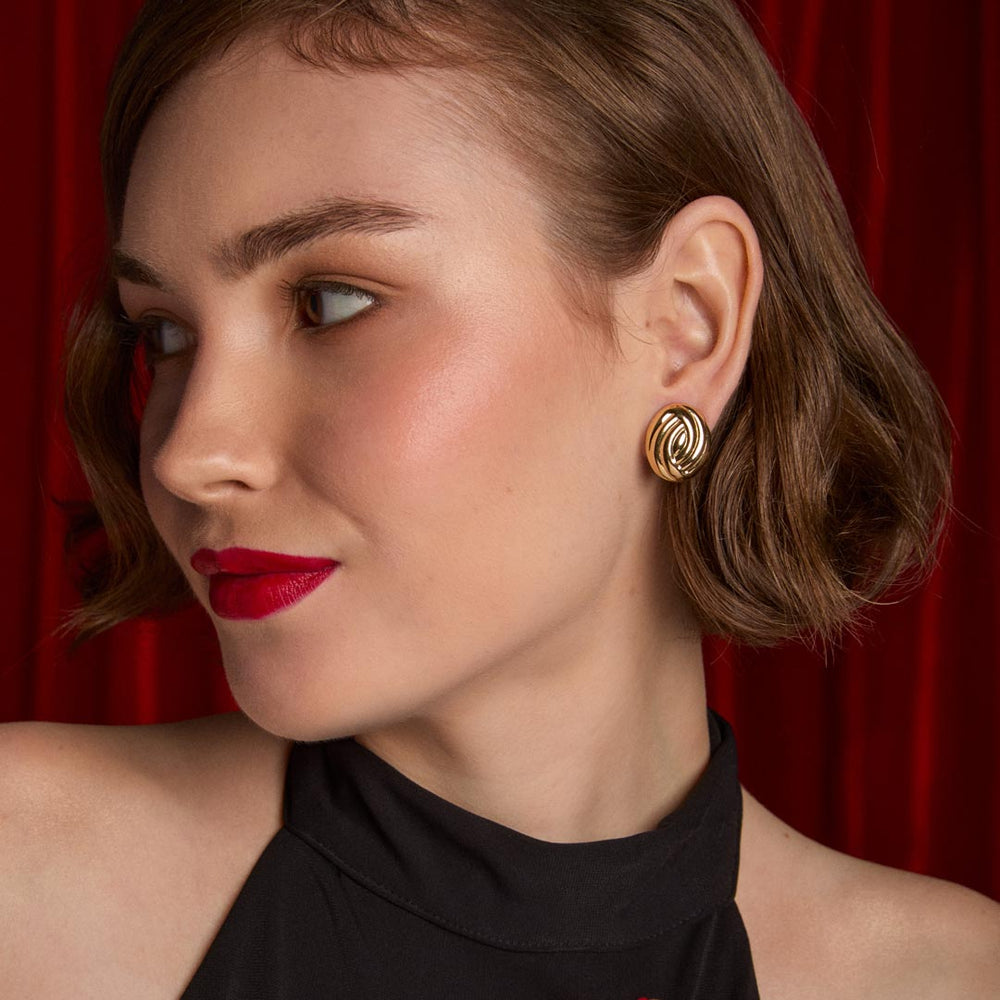 model wearing gold plated knot stud earrings