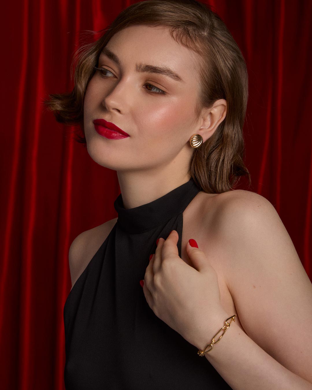 model wearing gold plated stud earrings and link bracelet