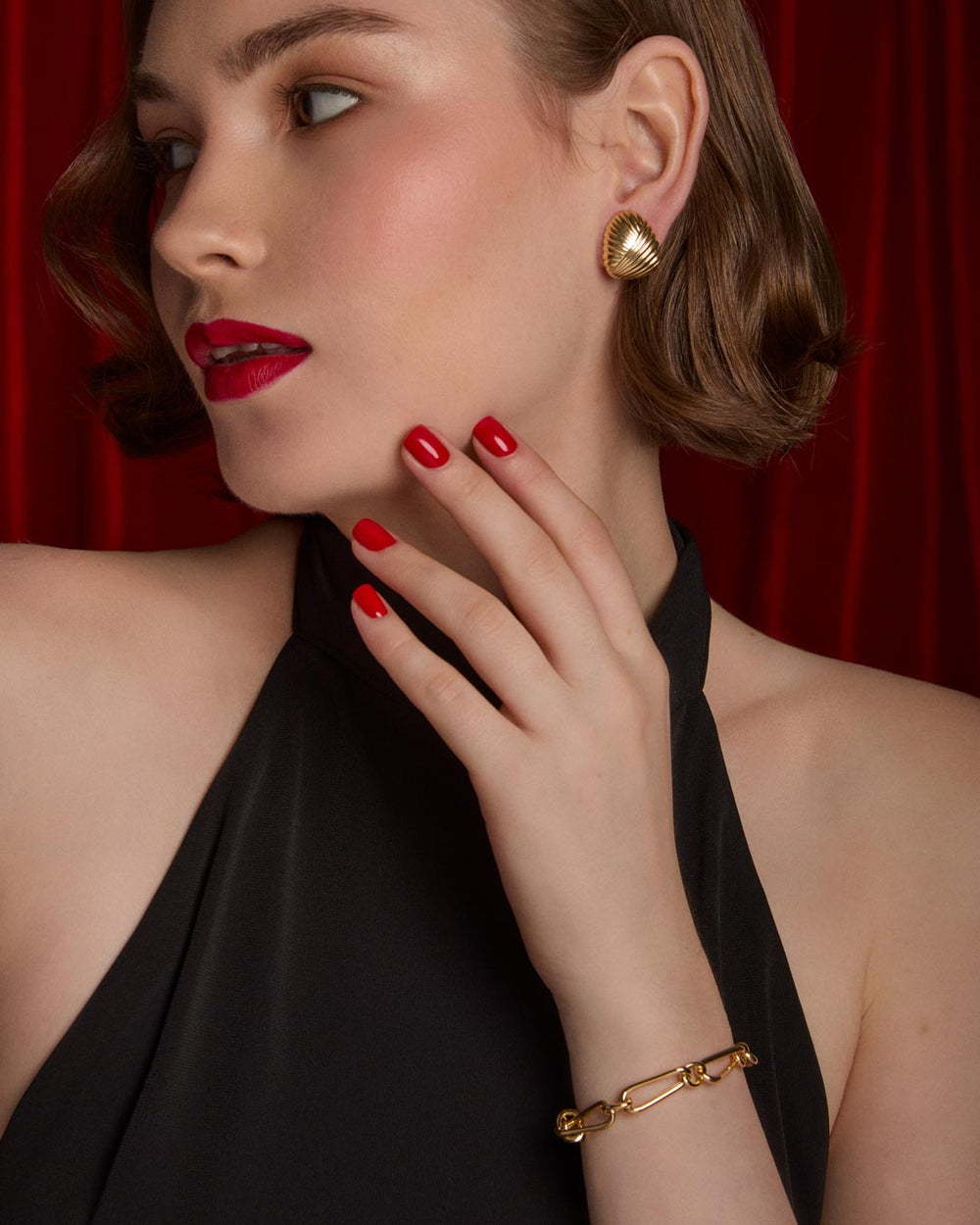 model wearing gold plated half hoop earrings and link bracelet