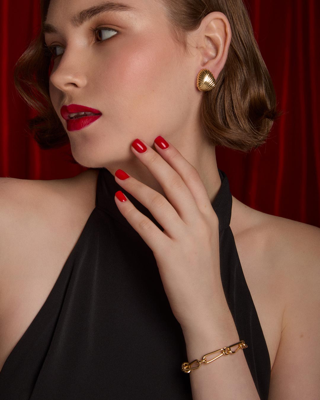 model wearing gold plated half hoop earrings and link bracelet