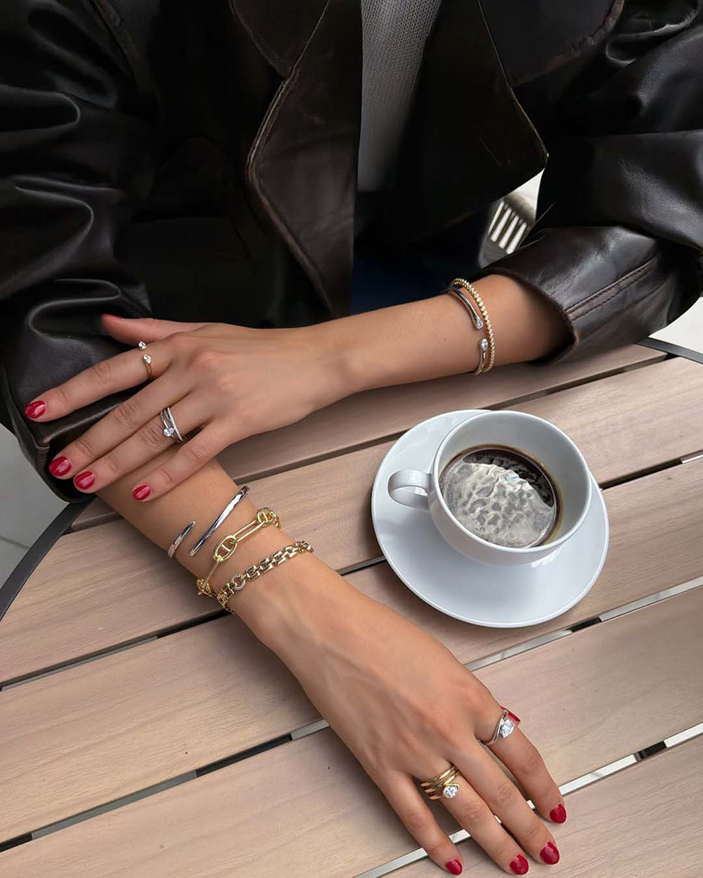 lifestyle shot of model wearing mixed metal bracelet stack and rings