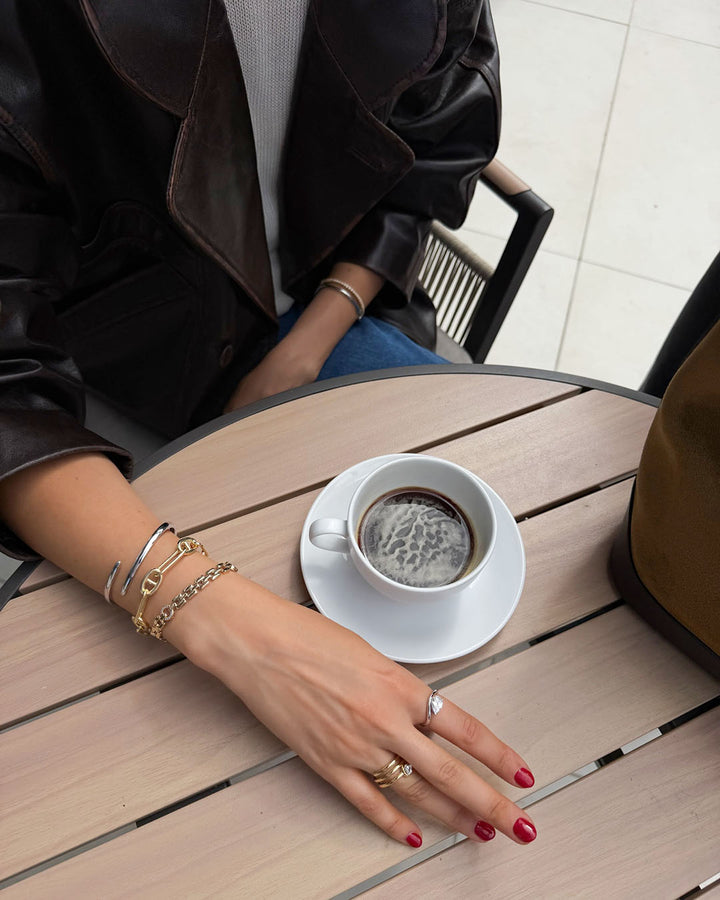 lifestyle shot of model wearing mixed metal bracelet stack and rings