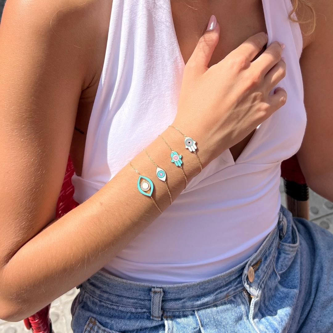 model wearing colourful gold plated bracelet stack