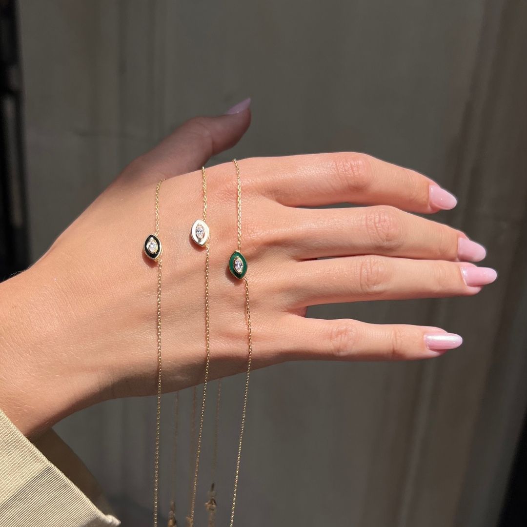 model showing gold plated evil eye necklaces on back of hand