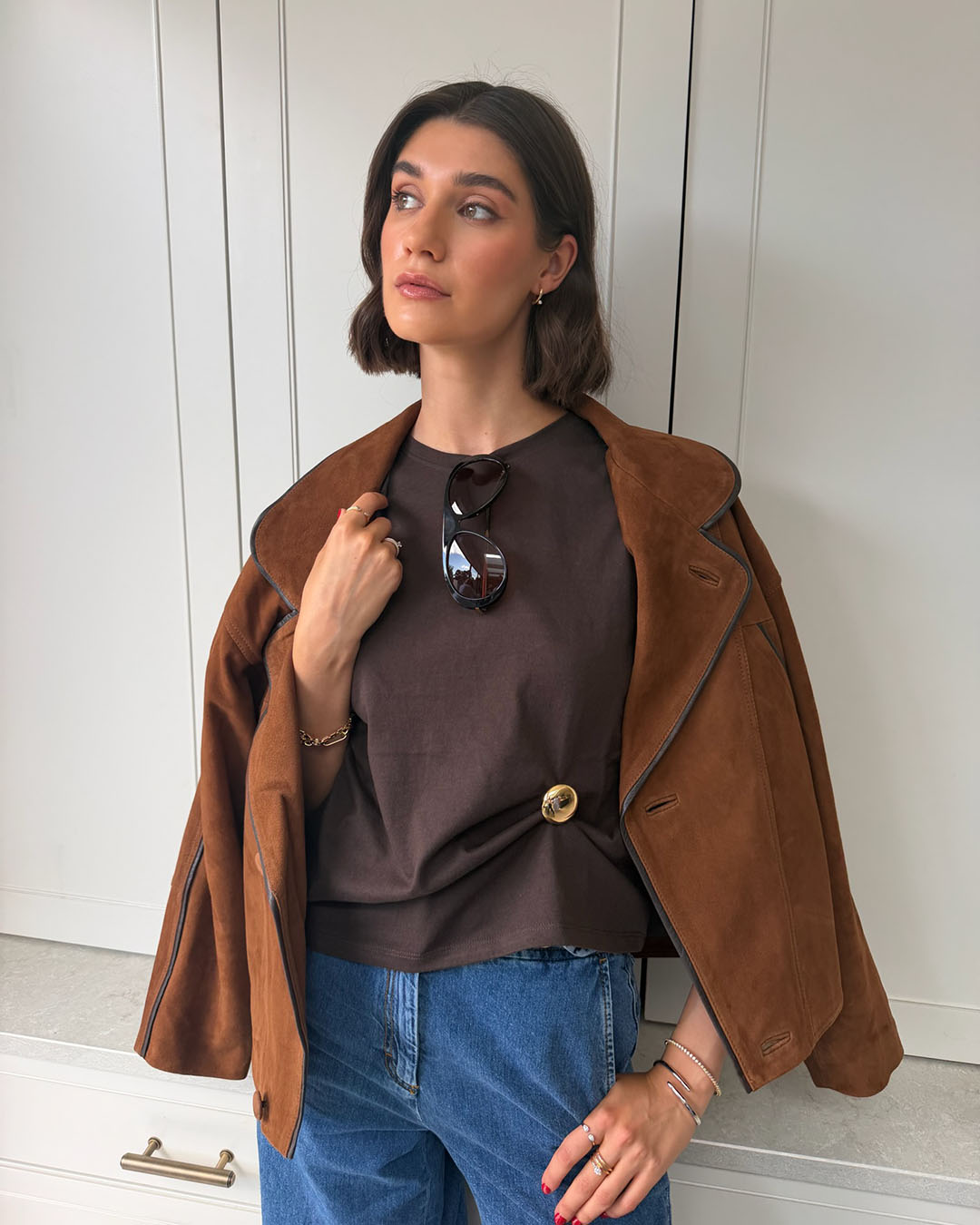 model wearing gold plated brooch and bracelets
