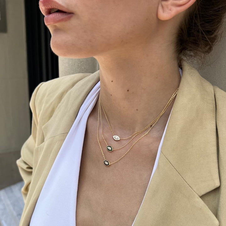 model wearing gold plated evil eye necklaces