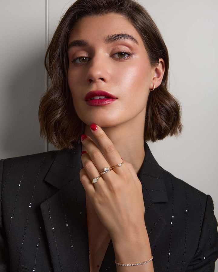 model wearing gold ring stack