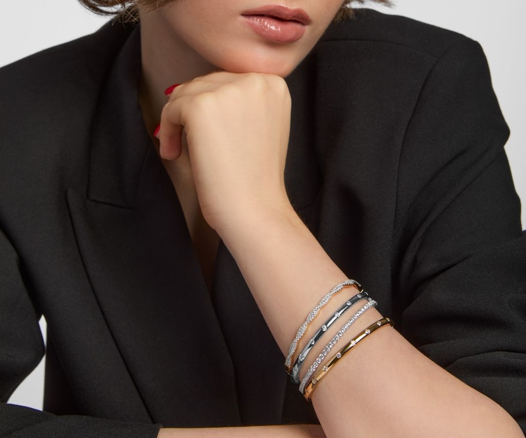 model wearing mixed metal bracelet stack
