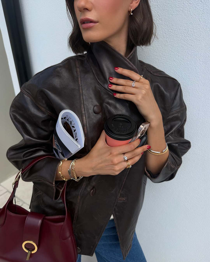 model wearing mixed metal bracelet stack and rings