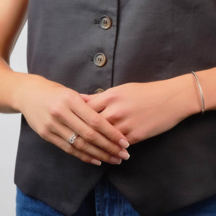 model wearing cz solitaire ring and wedding band set 