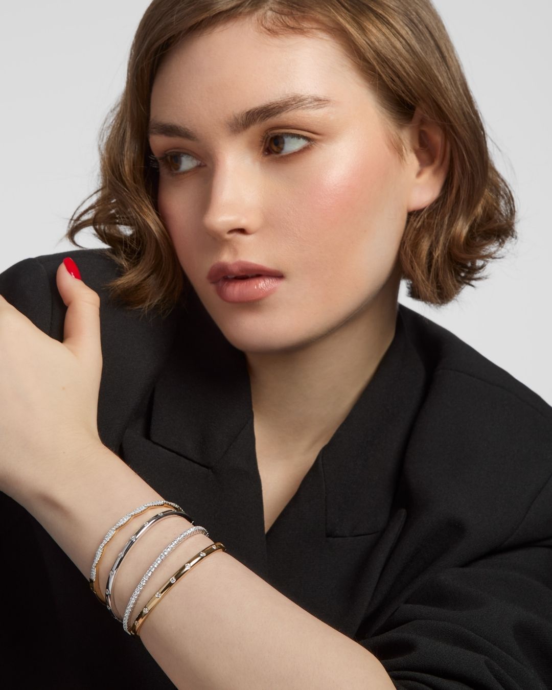 model wearing gold and silver bracelet stack