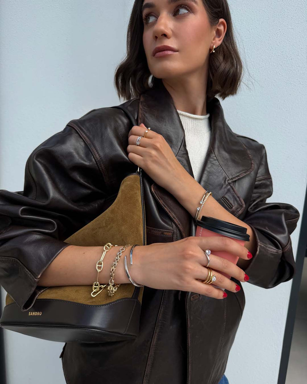 model wearing mixed metal bracelet stack and rings