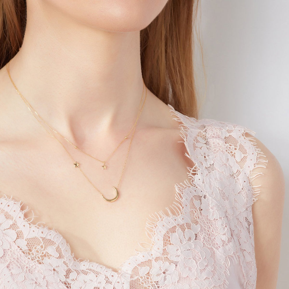 Model wearing 9ct Gold Moon & North Star Necklace