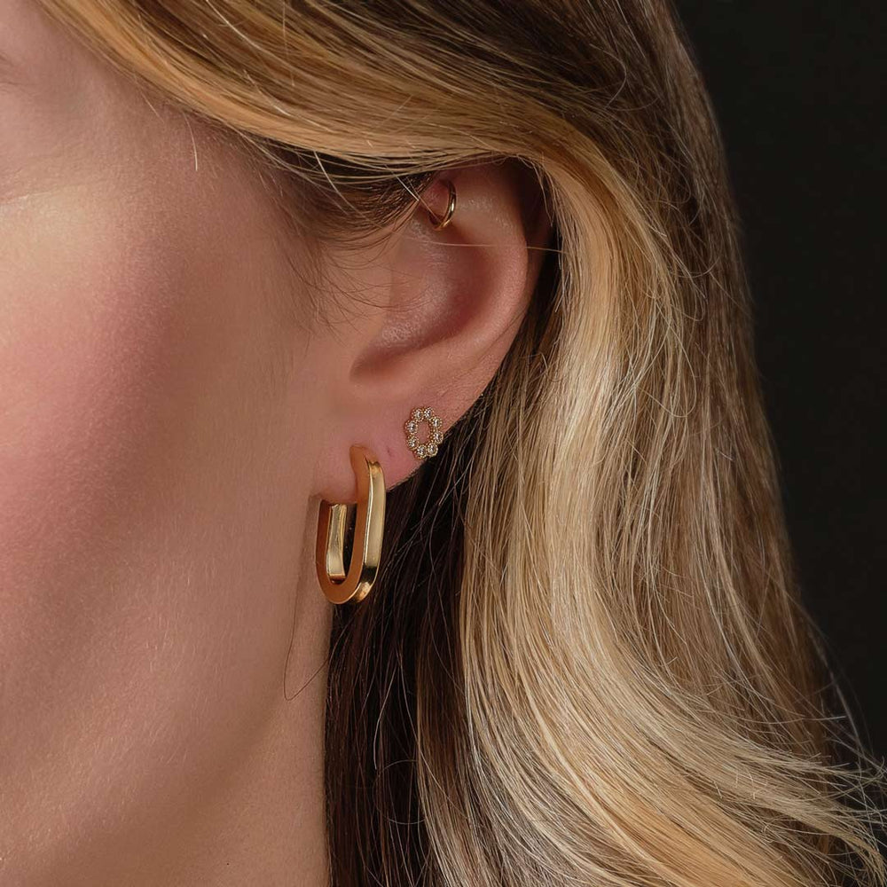 gold plated oval huggie hoop earrings on model