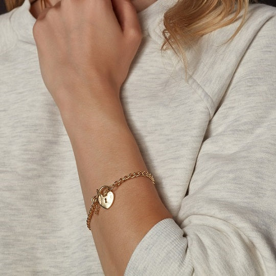 model wearing gold bracelet with lock design