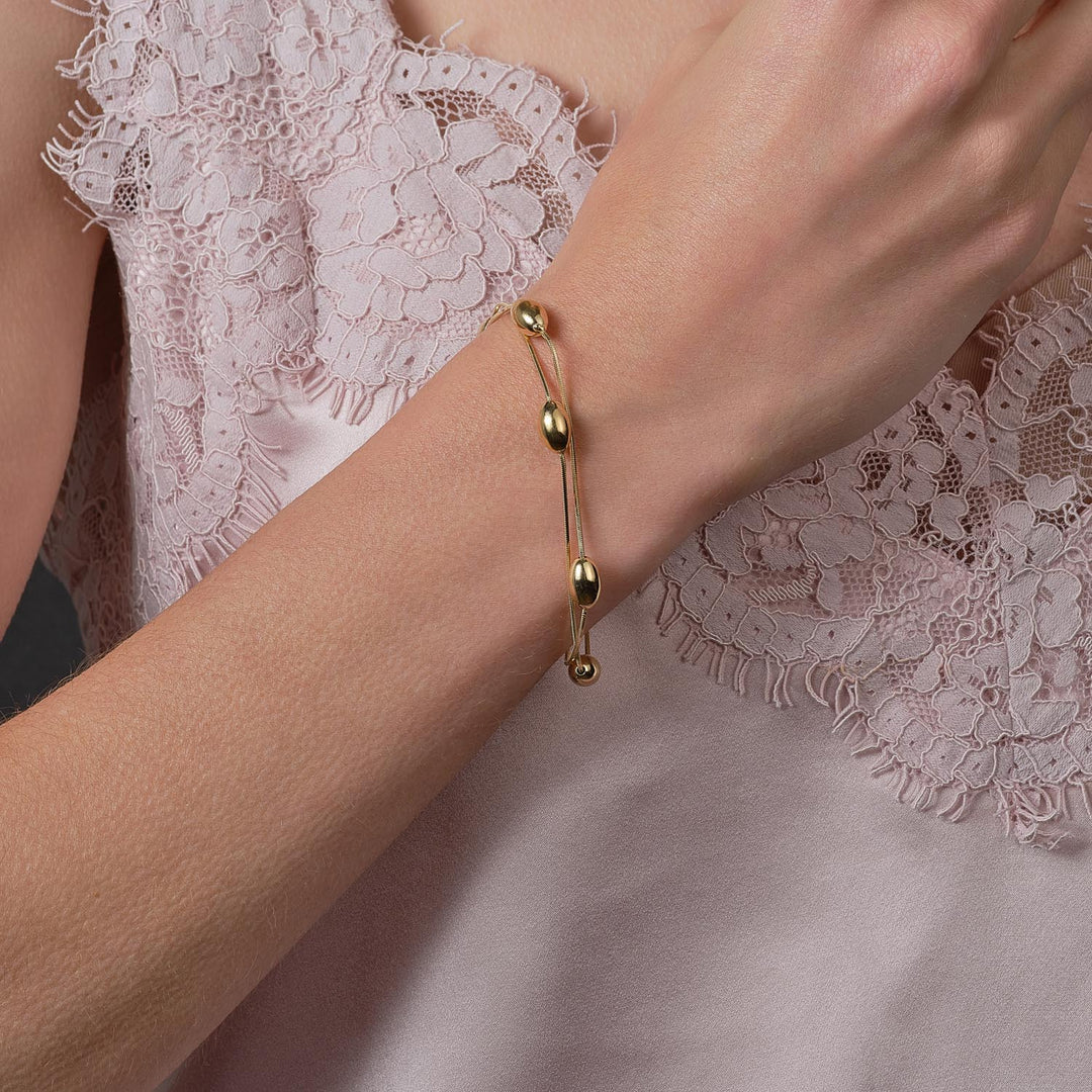 model wearing sterling silver bracelet with 18ct gold coating