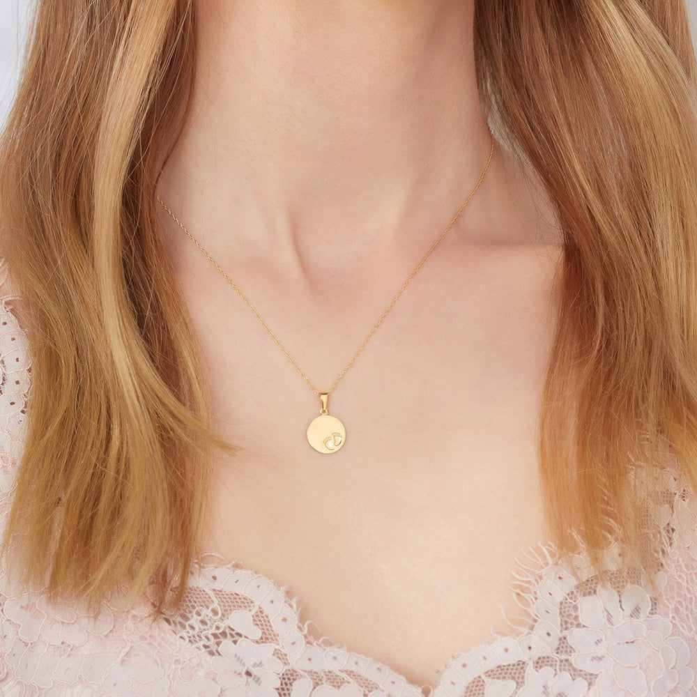 Model wearing  9ct gold baby footprint necklace from NJO Designs
