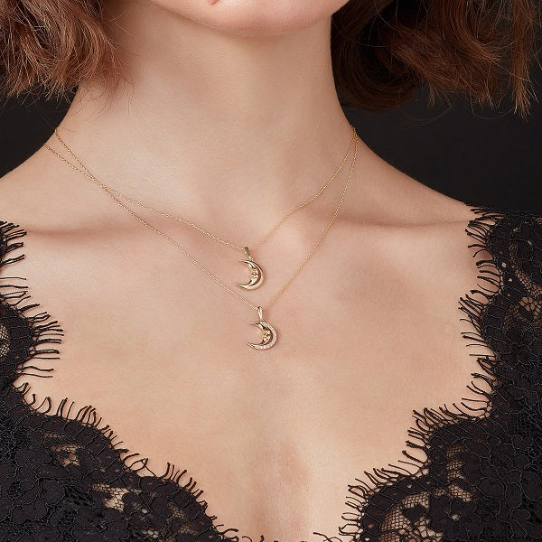9ct gold crescent moon with cubic zirconia on model