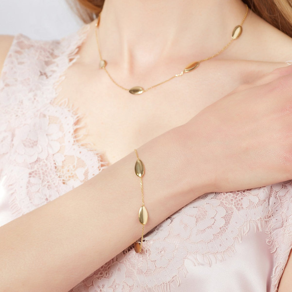Model shot of oval design gold bracelet