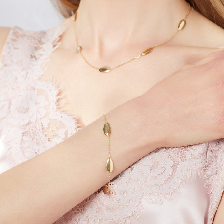 Model shot of oval design gold bracelet