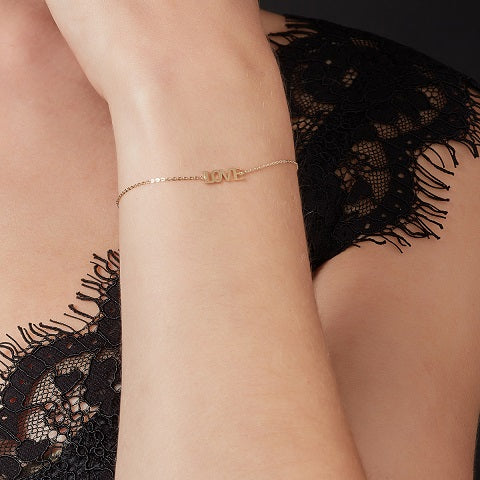 model wearing 9ct gold love bracelet