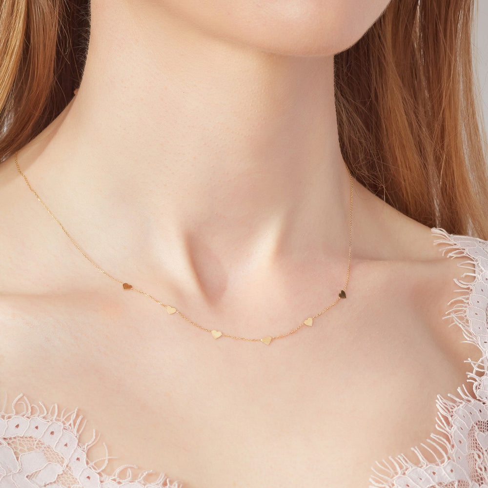 model wearing 9ct gold 5 heart necklace