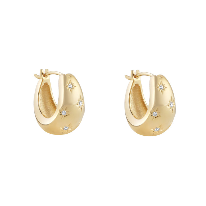 gold chunky cz star huggie earrings on white background