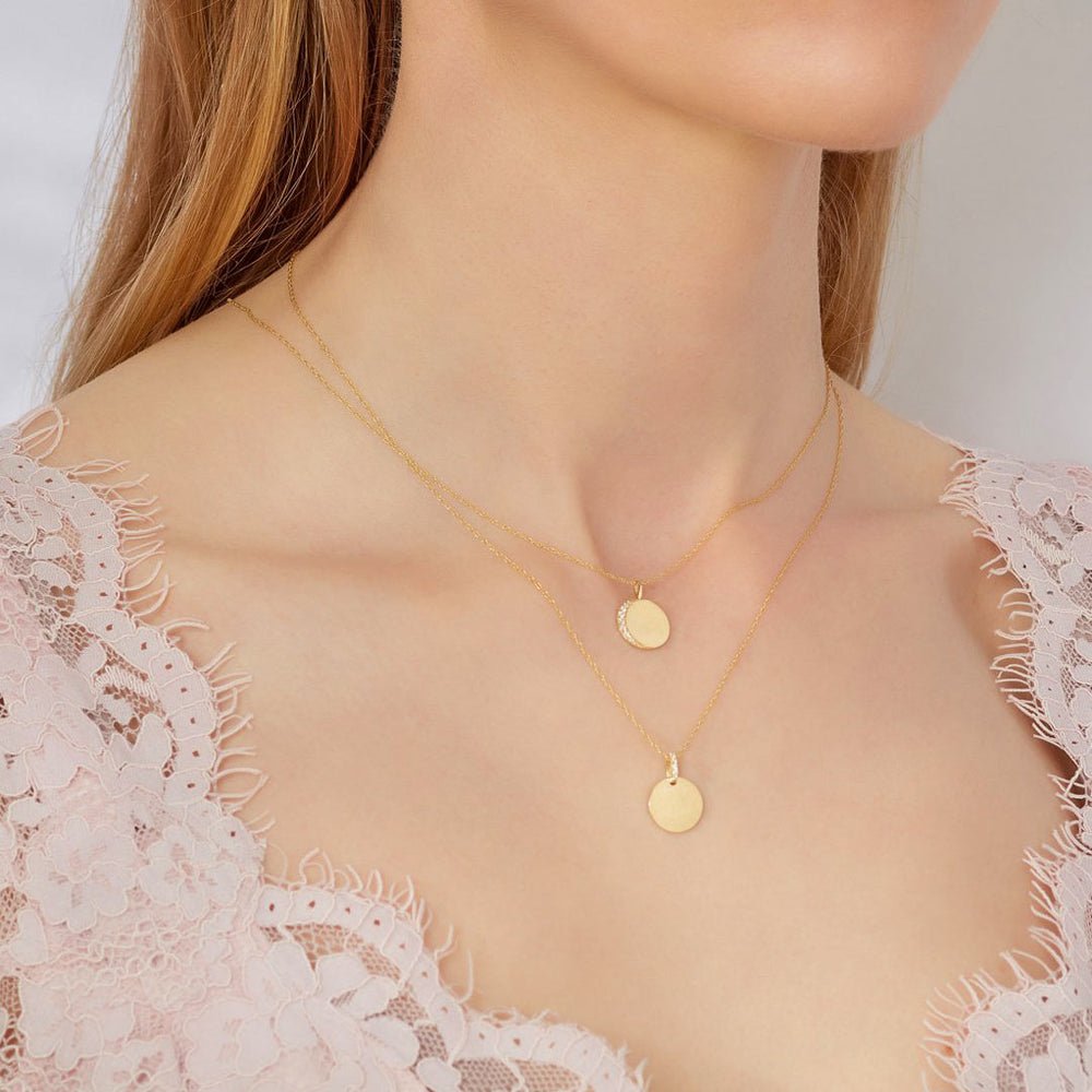yellow gold engravable disc necklaces on a model
