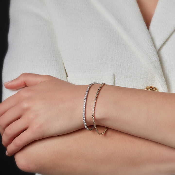 tennis bracelets layered on models arm