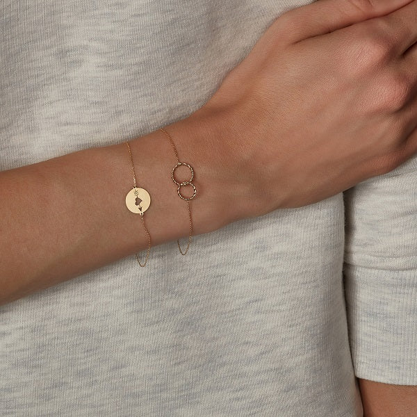 models wrist wearing 9ct yellow gold circle bracelet