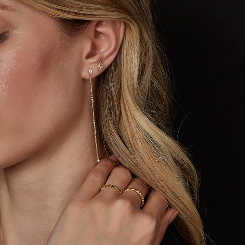 9ct gold lightning stud earrings on model