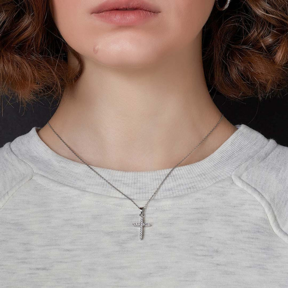 model wearing cz cross pendant on 18-inch silver rolo chain