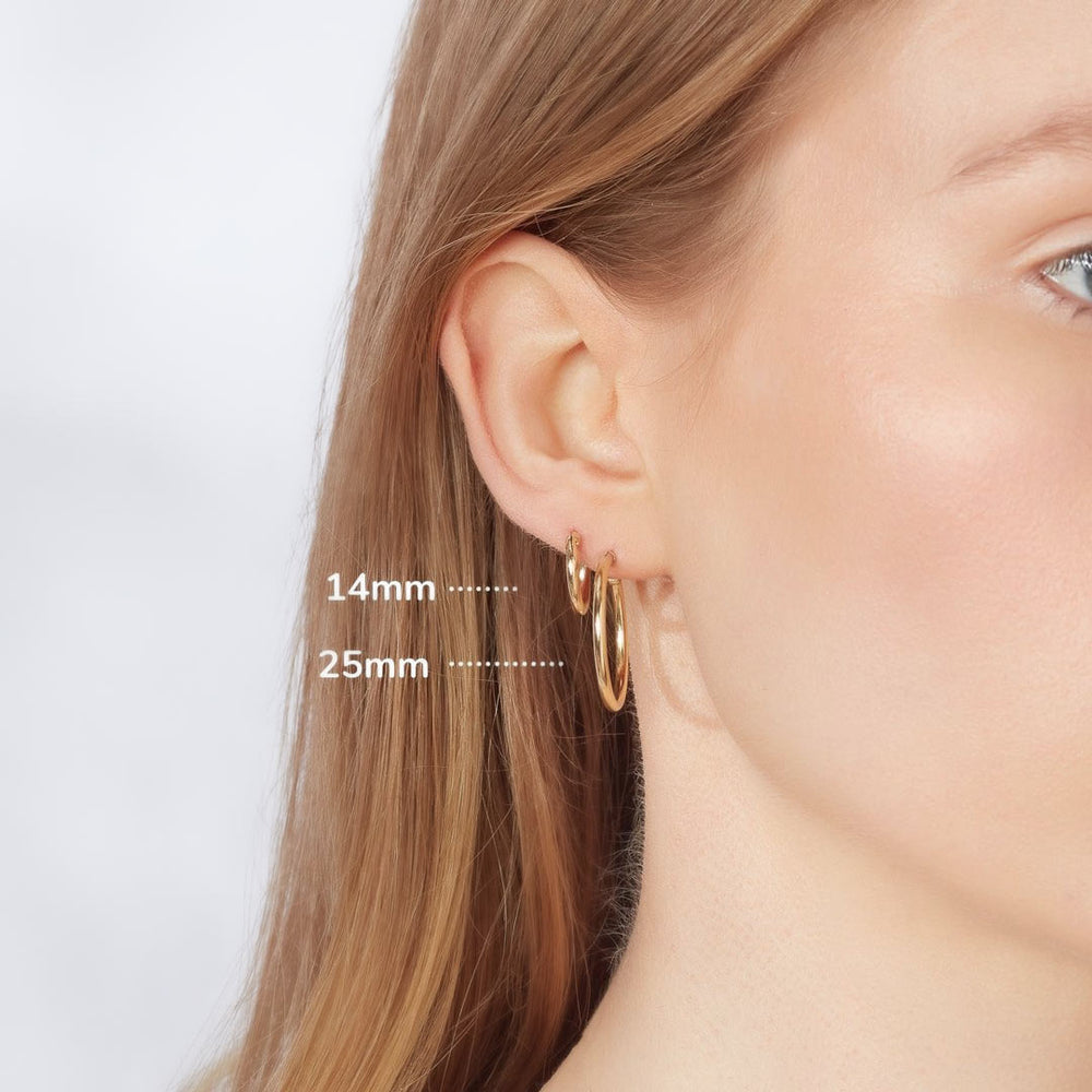 yellow gold sleeper earrings on model